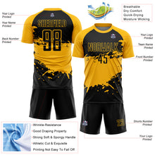 Laden Sie das Bild in den Galerie-Viewer, Custom Black Gold Splash Sublimation Soccer Uniform Jersey