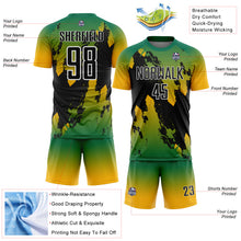 Laden Sie das Bild in den Galerie-Viewer, Custom Kelly Green Black Gold-White Gradient Splash Sublimation Soccer Uniform Jersey
