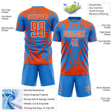 Charger l'image dans la galerie, Custom Powder Blue Orange-White Splatter Torn Sharp Brush Stroke Sublimation Soccer Uniform Jersey