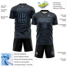 Laden Sie das Bild in den Galerie-Viewer, Custom Black-Light Blue Abstract Wave Lines Interlocking Sublimation Soccer Uniform Jersey