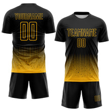 Laden Sie das Bild in den Galerie-Viewer, Custom Black-Gold Fade Wave Lines Splatter Sublimation Soccer Uniform Jersey

