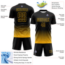 Laden Sie das Bild in den Galerie-Viewer, Custom Black-Gold Fade Wave Lines Splatter Sublimation Soccer Uniform Jersey
